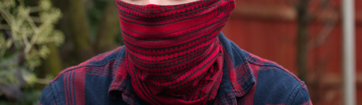 Man wearing red and black neck gaiter